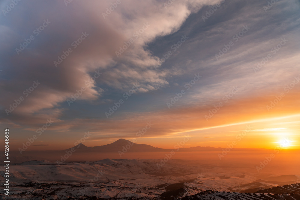 Beautiful panoramic winter landscape on the sunset . The mountain and hill snow-covered on the sunset.