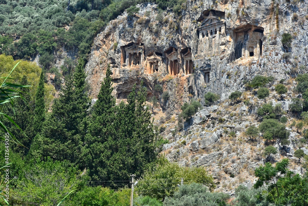 Amazing view of the Lycian tombs carved into the rock on the Dalyan River, ancient Caunos town, Turkey, Mugla. Turkish famous historical landmark