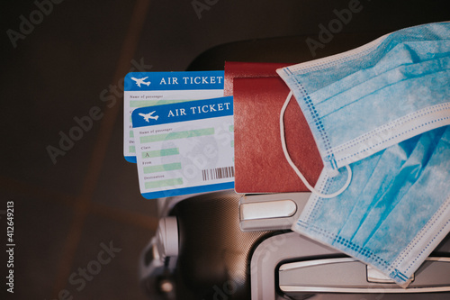 COVID-19 travel restriction due to the use of mandatory corona virus mask on airplane flights. Passport, plane ticket and suitcase ready for vacation.
Vaccination Passport, VUI 20201201 photo