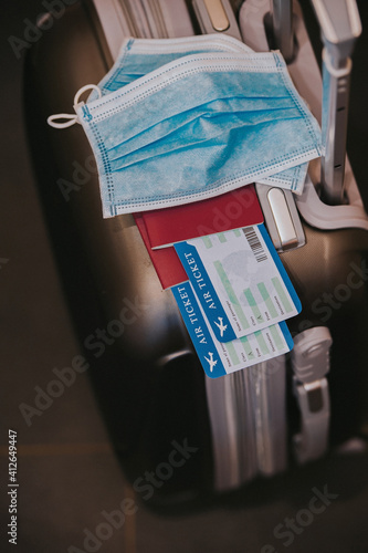 COVID-19 travel restriction due to the use of mandatory corona virus mask on airplane flights. Passport, plane ticket and suitcase ready for vacation.
Vaccination Passport, VUI 20201201 photo