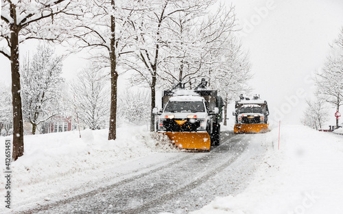 Canvastavla snow plowing machine in suburban neighborhood during northeastern storm nor'east