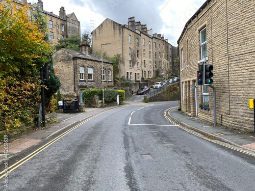 View along, Keighley Road, with Victorian stone buildings, on a cloudy autumn day in, Hebden Bridge, Yorkshire, UK