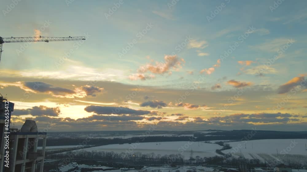 Aerial view of cement plant with high factory structure and tower crane at industrial production area at sunset. Aerial view of cement plant with high factory structure and tower crane at industrial production area at sunset.