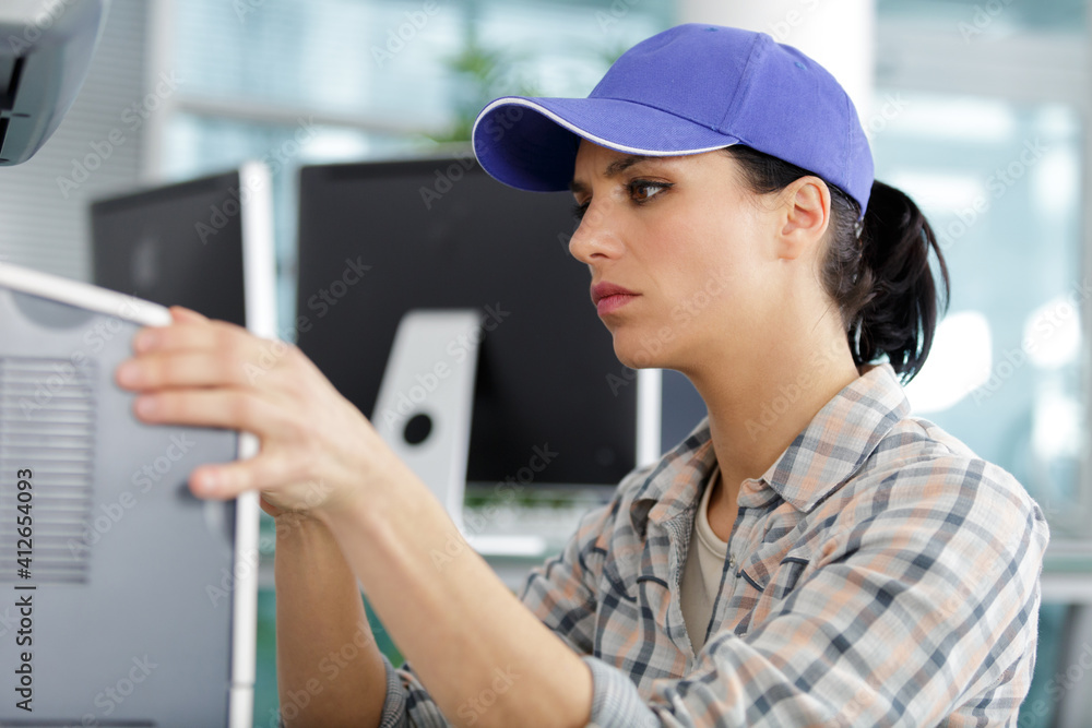 female technician checking electrical appliance female technician checking electrical appliance