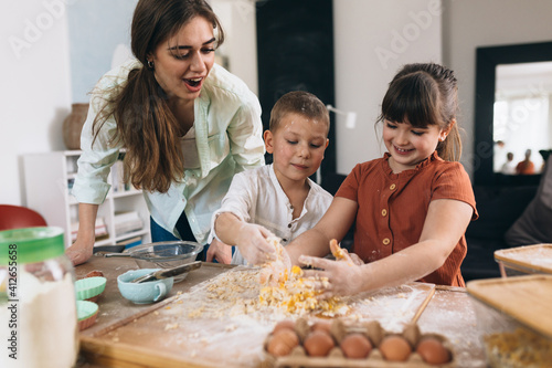 mother with her kids baking together in their home