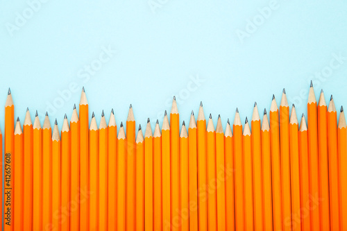 Yellow pencils on blue background