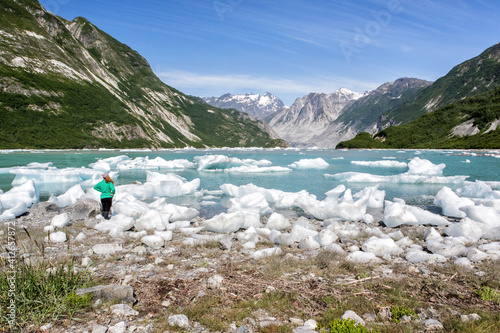 Slika na platnu Woman admires ice and mountain beauty of McBride Inlet in Glacier Bay