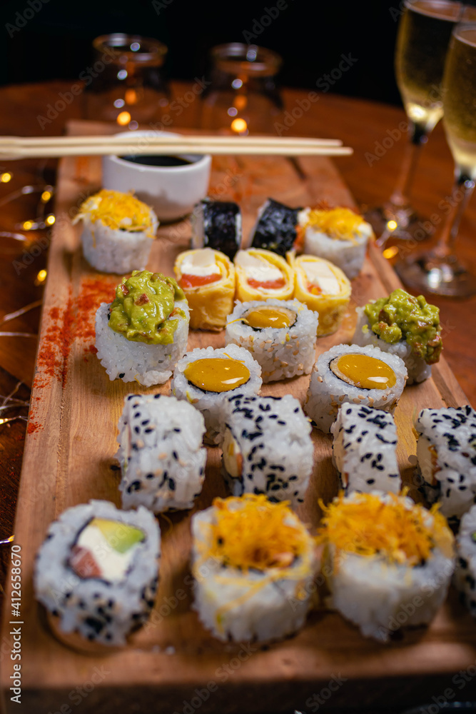 close-up of sushi food on wooden base with dark background for valentine's day dinner with champagne glasses cordoba argentina