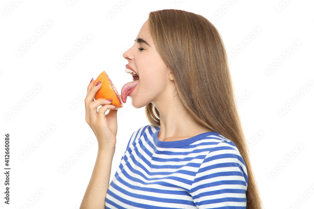 Young girl eating fresh grapefruit on white background Young girl eating fresh grapefruit on white background