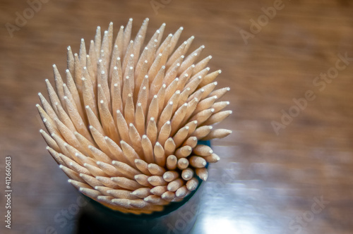 A lot of wooden toothpicks. Round pointy texture background of yellow and brown.