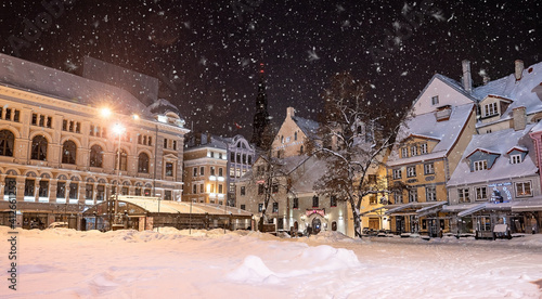 Beautiful winter night in Riga, Latvia. Winter wonderland with cosy houses at night.