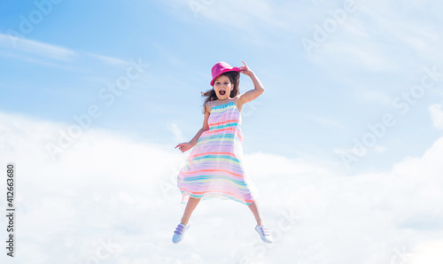 spring season weather. summer fashionable look. freedom. beautiful teen girl jump in hat. kid fashion style. female natural beauty. happy childhood. cute child on sky background. Fashion is her life