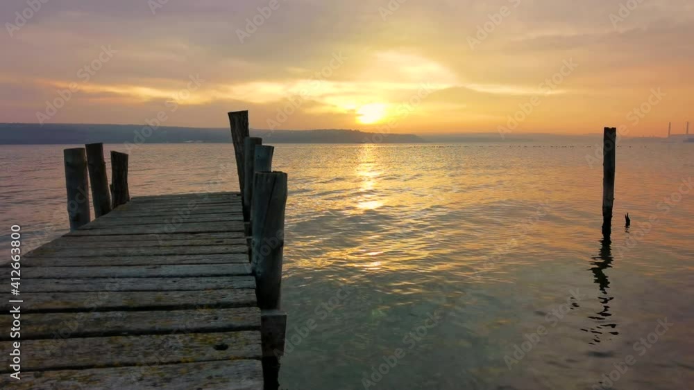 Idyllic sunset at the seashore with a wooden pier. Time for relaxing Idyllic sunset at the seashore with a wooden pier. Time for relaxing