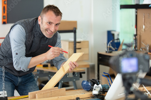 man making a diy blog recording in front of camera