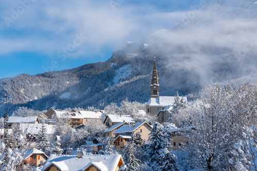 The village of Saint Leger les Melezes in the Champsaur Valley covered in snow in winter. Ski resort in the Ecrins National Park, French Alps, Hautes Alpes, France photo