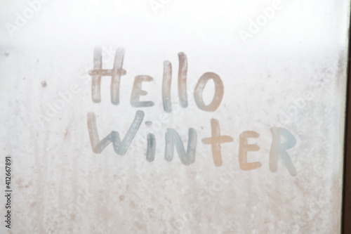 Hello winter. The inscription on the frozen glass.