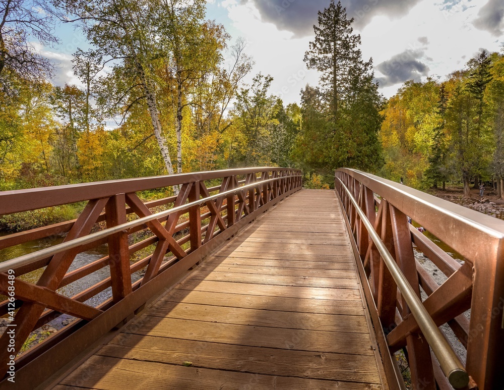 Beautiful wooden bridge over Gooseberry River at Gooseberry Falls State Park in northern Minnesota
