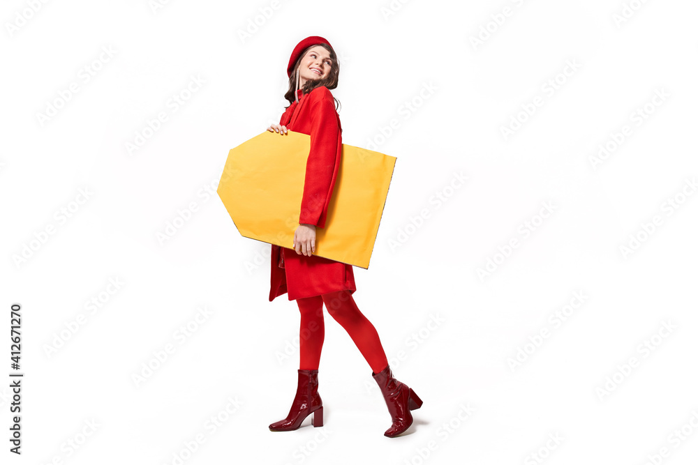 Trendy girl standing with shopping label in hand