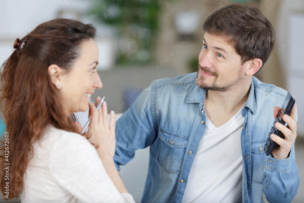 portrait of a cheerful couple calculating their bills portrait of a cheerful couple calculating their bills