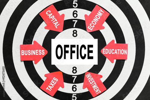 On the target, arrows with business lettering point to the center on a business card with the inscription - OFFICE