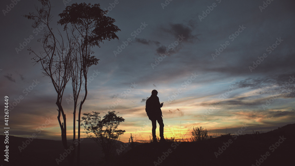 man's silhouette in an colorful evening sky