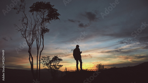 man s silhouette in an colorful evening sky