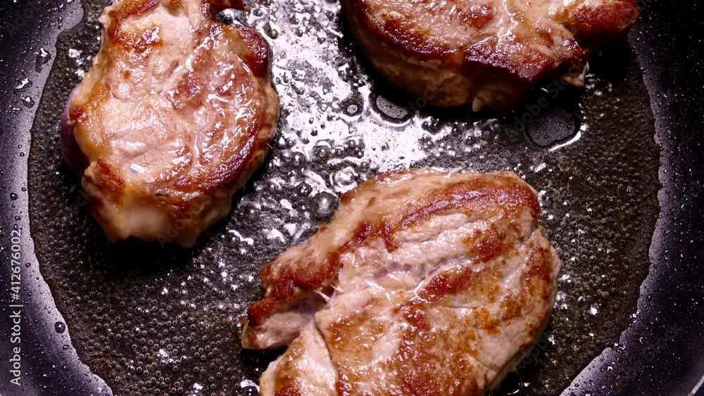 Fry the steak in a pan. Prepare a dish of pieces of meat. Pork with crispy crust close-up. Fry the steak in a pan. Prepare a dish of pieces of meat. Pork with crispy crust close-up.