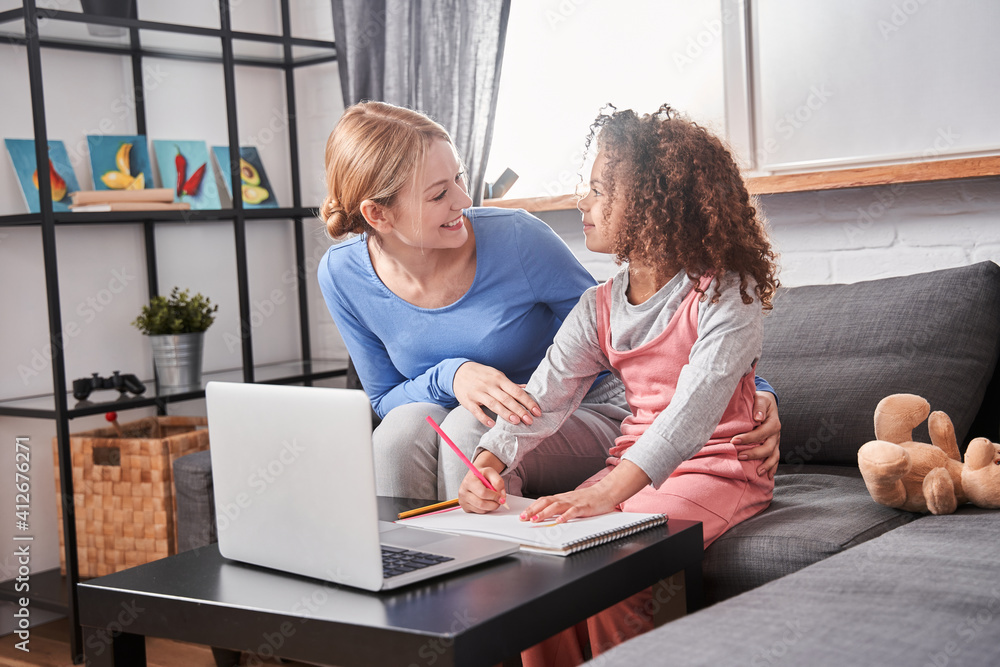 Mother laughing to her daughter while teach together Mother laughing to her daughter while teach together