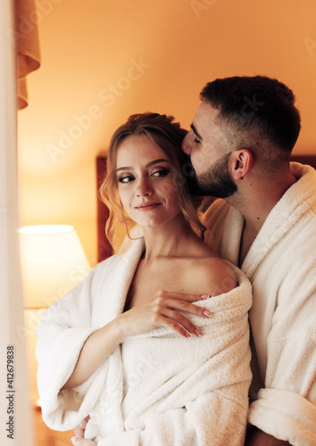 lovers in bathrobes in the bedroom