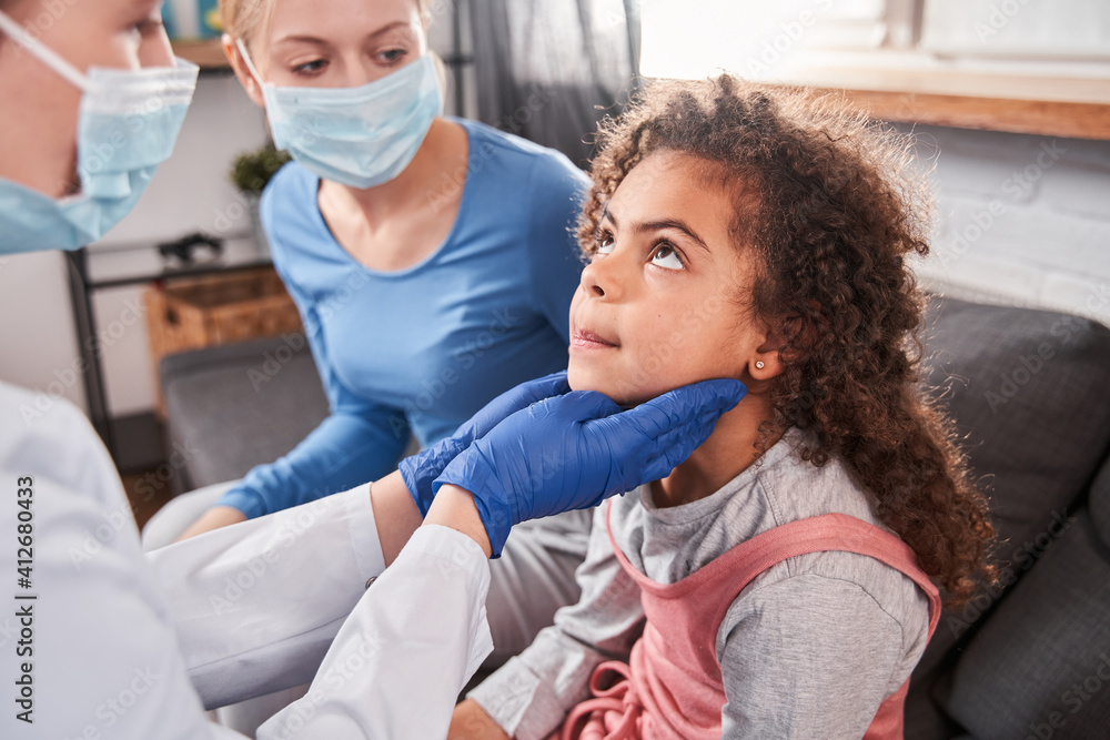 Doctor checking lymph nodes while ill girl sitting Doctor checking lymph nodes while ill girl sitting