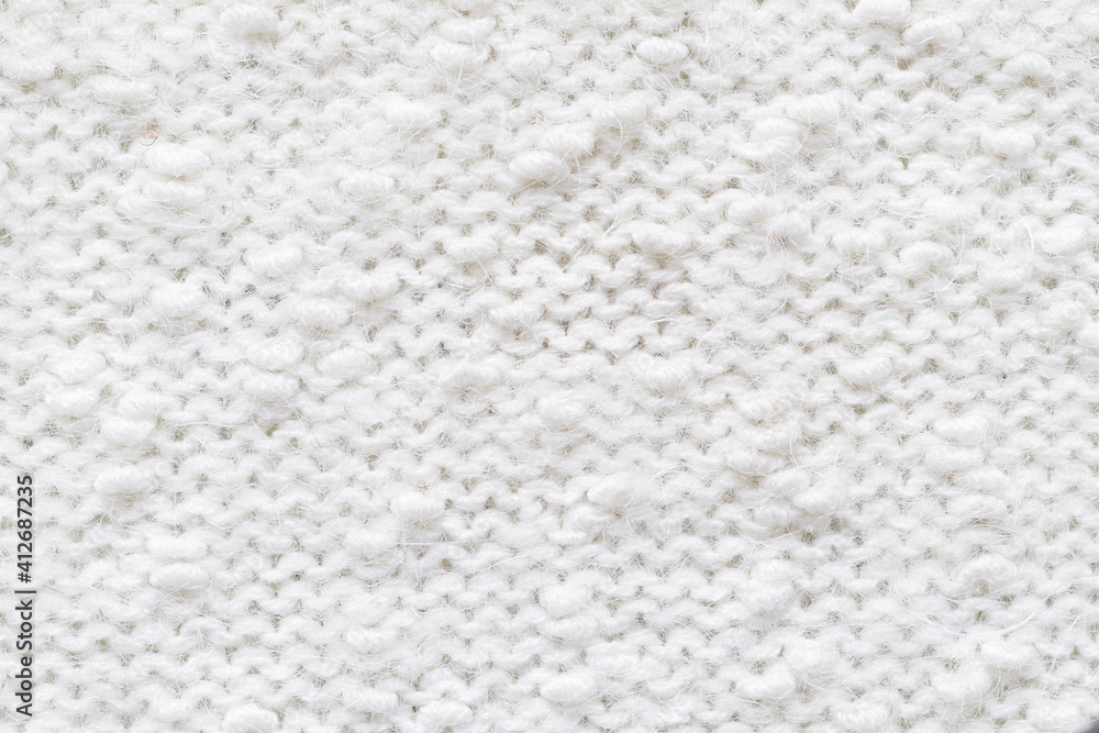 Knitted loops background. Knitted texture. White Knitted Fabric Texture. White knitting wool texture background. Wool sweater texture close up. Knitted loops background. Knitted texture. White Knitted Fabric Texture. White knitting wool texture background. Wool sweater texture close up.