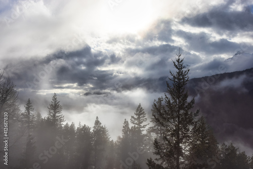 Dramatic Scenic Nature View of Canadian Mountain Landscape covered in clouds. Artistic Render. Located near Squamish and Whistler, British Columbia, Canada.