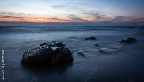 stones at sea at sunset and in the long exposition