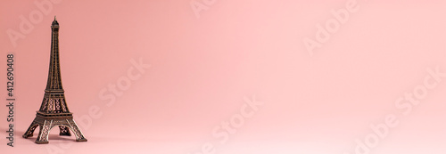 Canvas Print Banner of the small Eiffel Tower on pink background at the right side of the frame