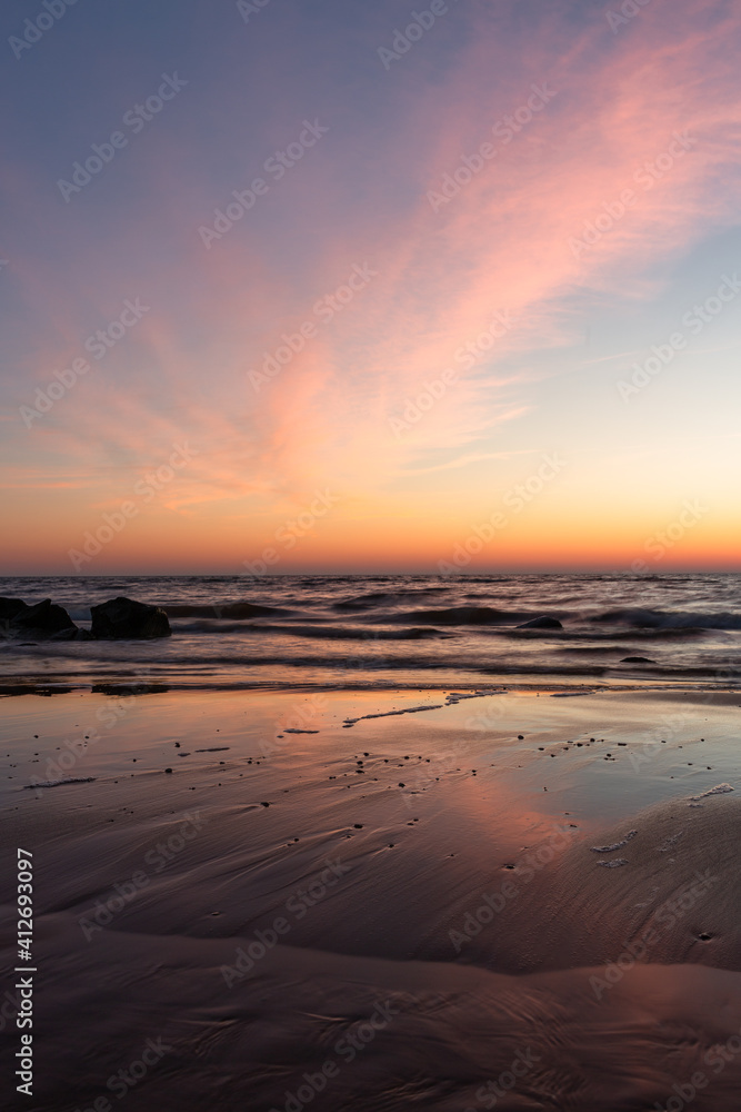 Baltic sea coast with stones at sunset