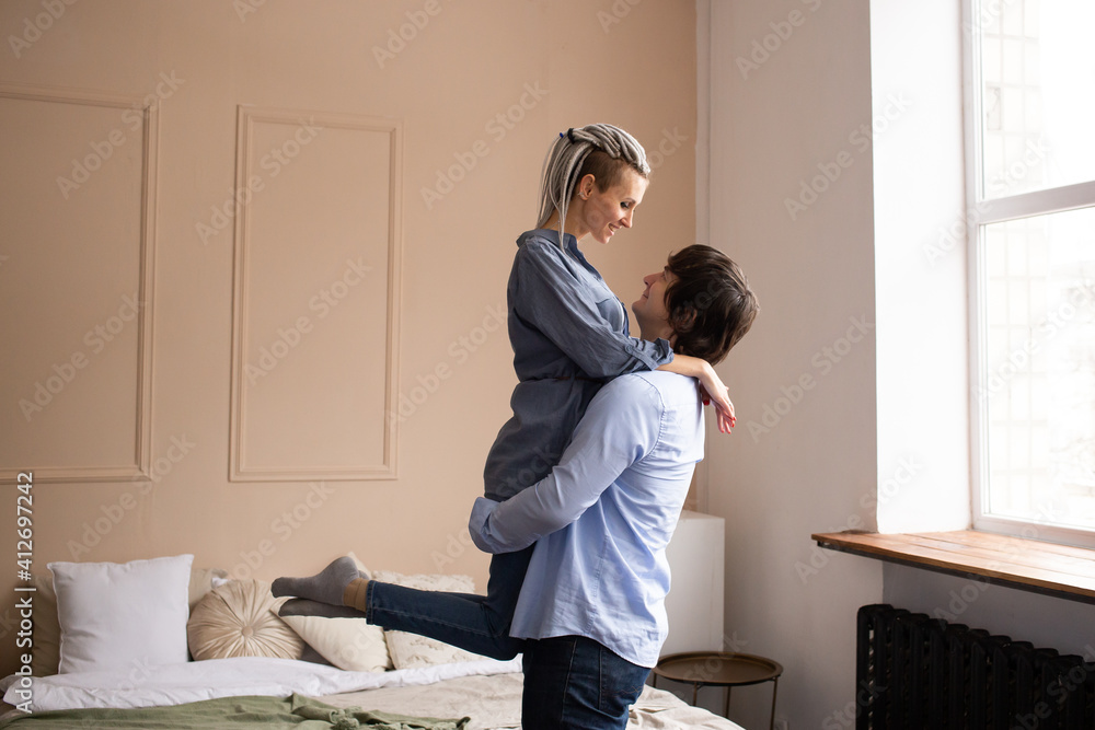 Couple hugging in bedroom and kissing, love and relationships concept. Celebrating Saint Valentine's Day. Couple hugging in bedroom and kissing, love and relationships concept. Celebrating Saint Valentine's Day.