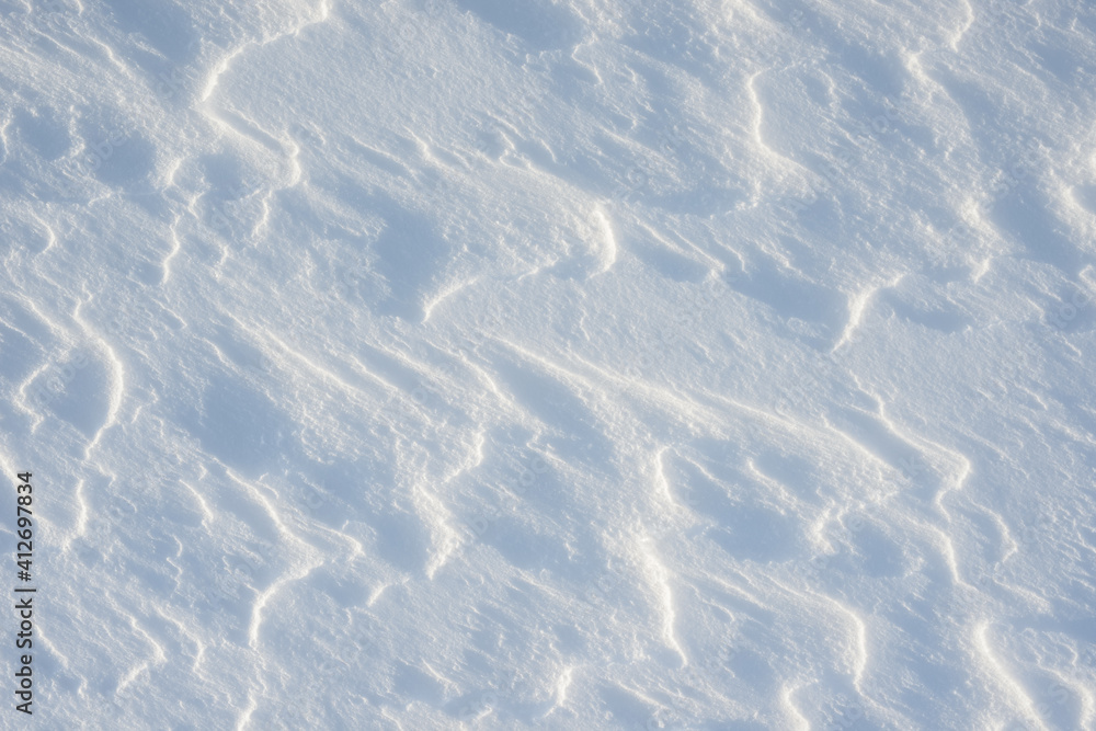 Fototapeta premium Fresh clean white snow background texture. Winter background with frozen snowflakes and snow mounds. Snow lumps. Seasonal landscape details. Cold weather.