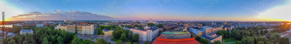 Aerial panoramic sunset view of Helsinki skyline from drone, Finland