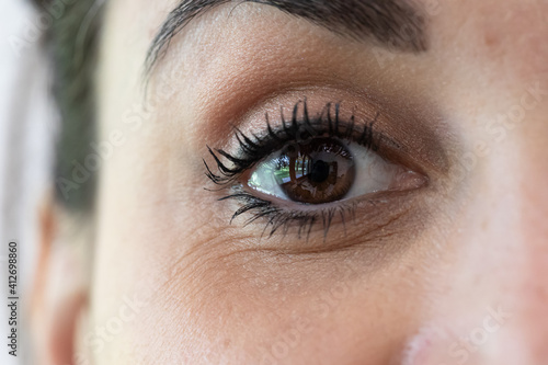 Foto Macro of a brown eye of a young brunette girl, detail of the iris and pupil