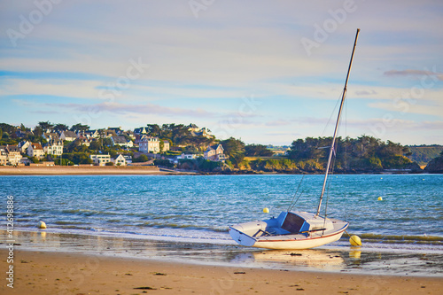 Yacht anchored on sand beach in Erquy, Brittany, France