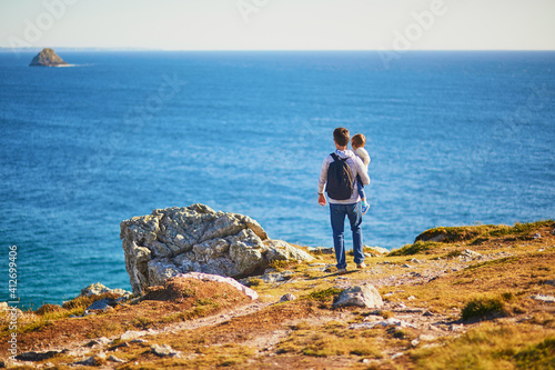Man and toddler girl enjoying scenic view of Crozon peninsula in Finistere, Brittany, France