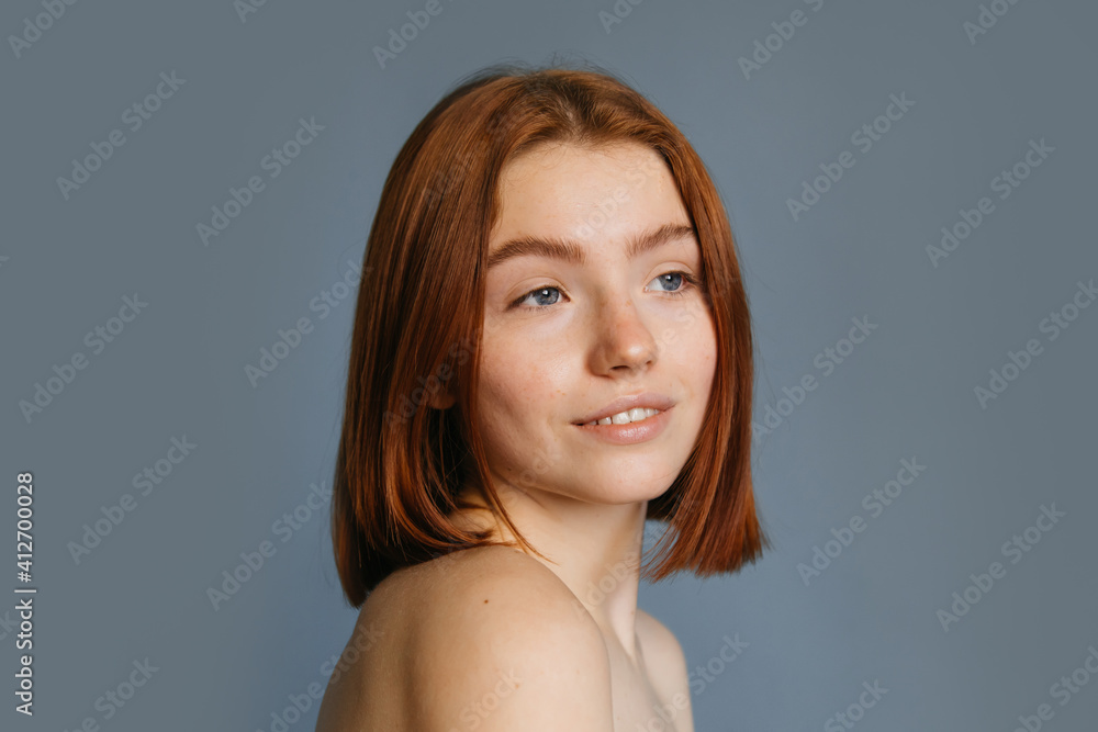 Woman with foxy short hair posing over grey background Woman with foxy short hair posing over grey background