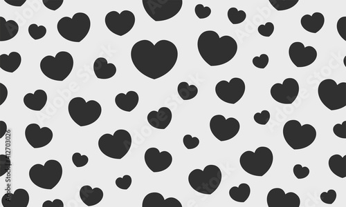 Endless seamless monochrome pattern of hearts of different sizes. Black and white vector hearts.