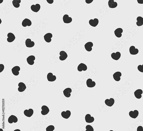 Endless seamless monochrome pattern of hearts of different directions. Black and white vector hearts. Wallpaper for wrapping paper.