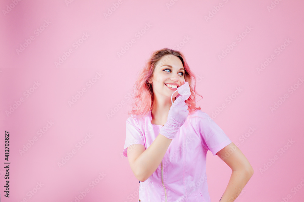 Portrait of beautiful young woman doctor nurse wearing protective mask corona virus prevention. Avoid contaminating Corona virus Covid-19 concept. Isolated pink background. Copy space