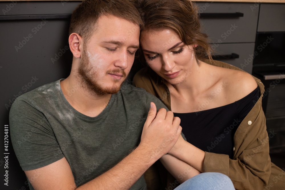 Portrait of couple in love hugging and spending time together at home sitting on the floor Portrait of couple in love hugging and spending time together at home sitting on the floor