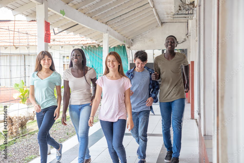 Group of mixed races happy teenagers laughing at school Group of mixed races happy teenagers laughing at school