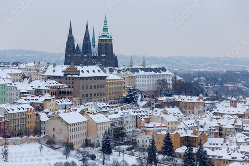 Snowy Prague City with gothic Castle from Hill Petrin, Czech republic