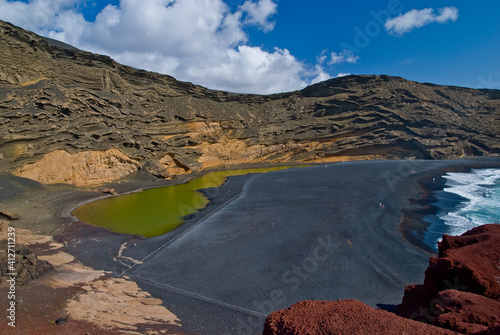 A view of green lagoon of El Golfo or Lago Verde on Lanzarote - a beautiful green lake near the village of El Golfo in Lanzarote, Canary islands, Spain