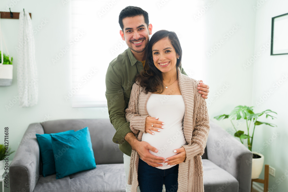 Couple embracing together the belly of the pregnant woman Couple embracing together the belly of the pregnant woman